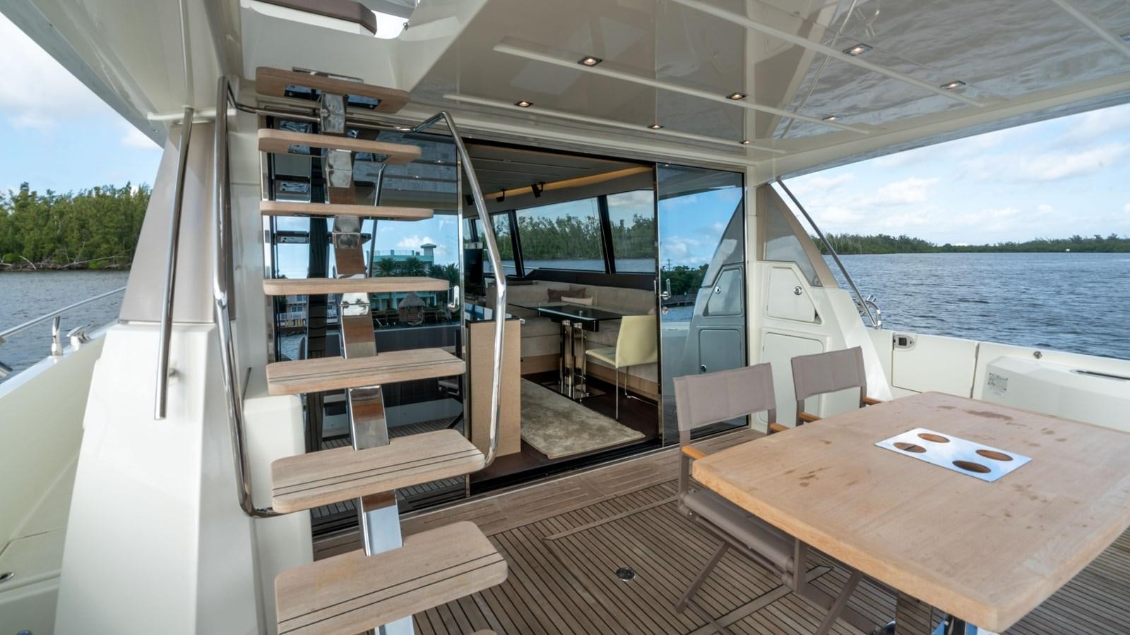 a boat with a table and chairs aboard VIMA Yacht for Sale