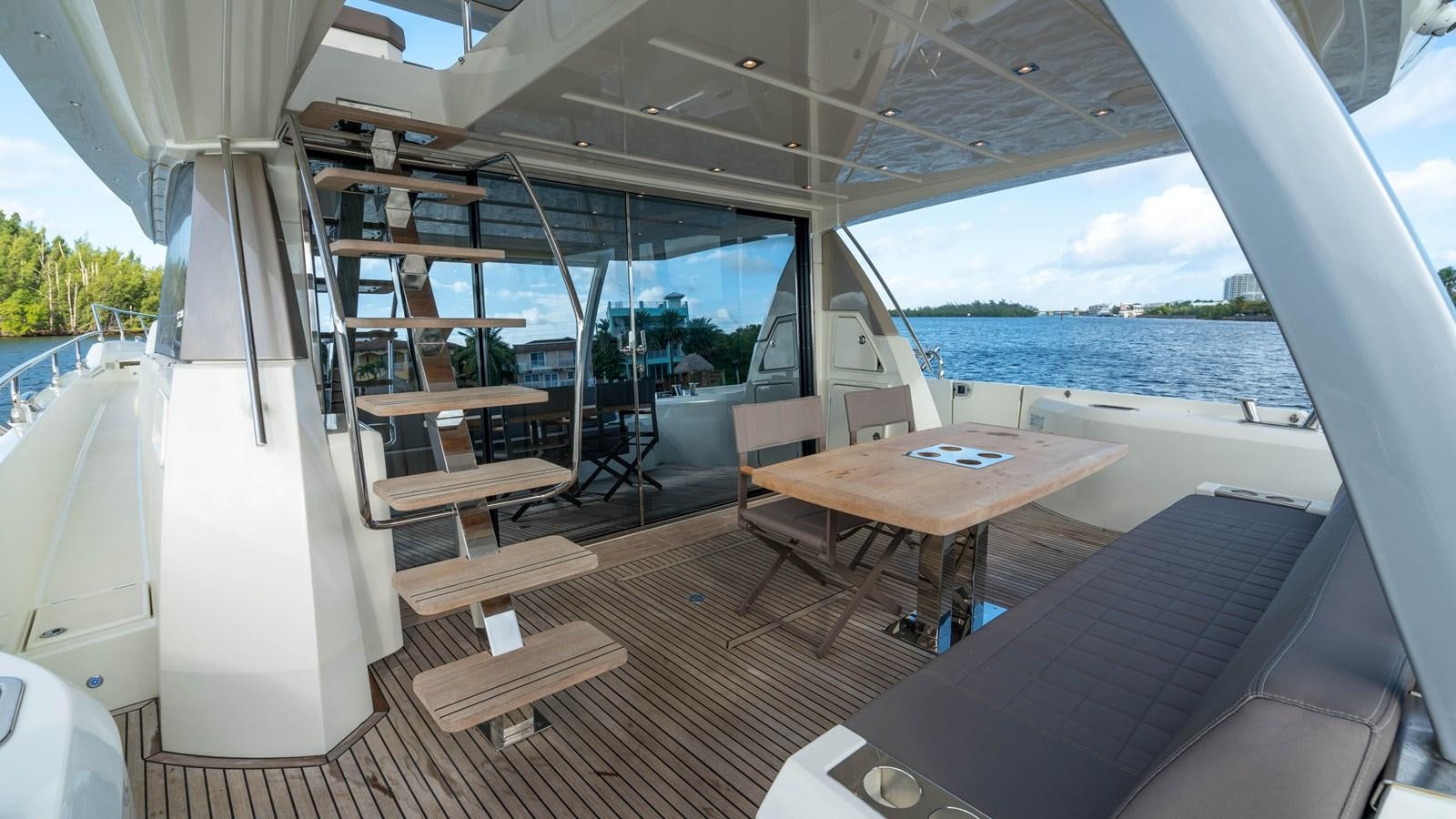 a room with a table and chairs aboard VIMA Yacht for Sale