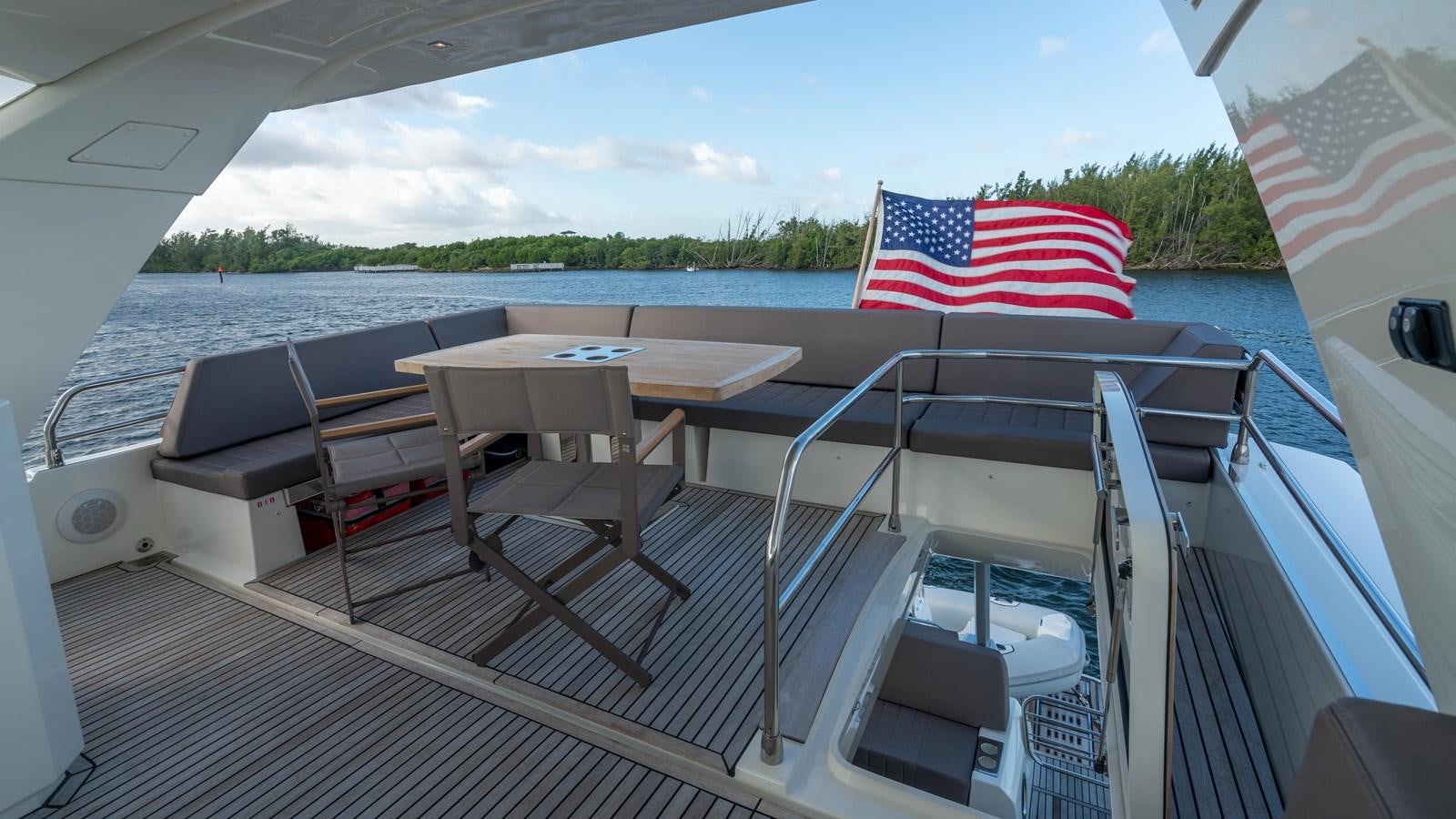 a boat with a flag on the deck aboard VIMA Yacht for Sale