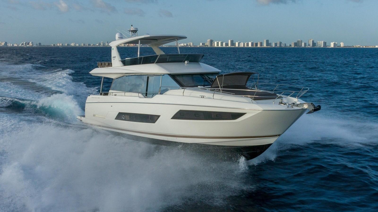 a white yacht on the water aboard VIMA Yacht for Sale