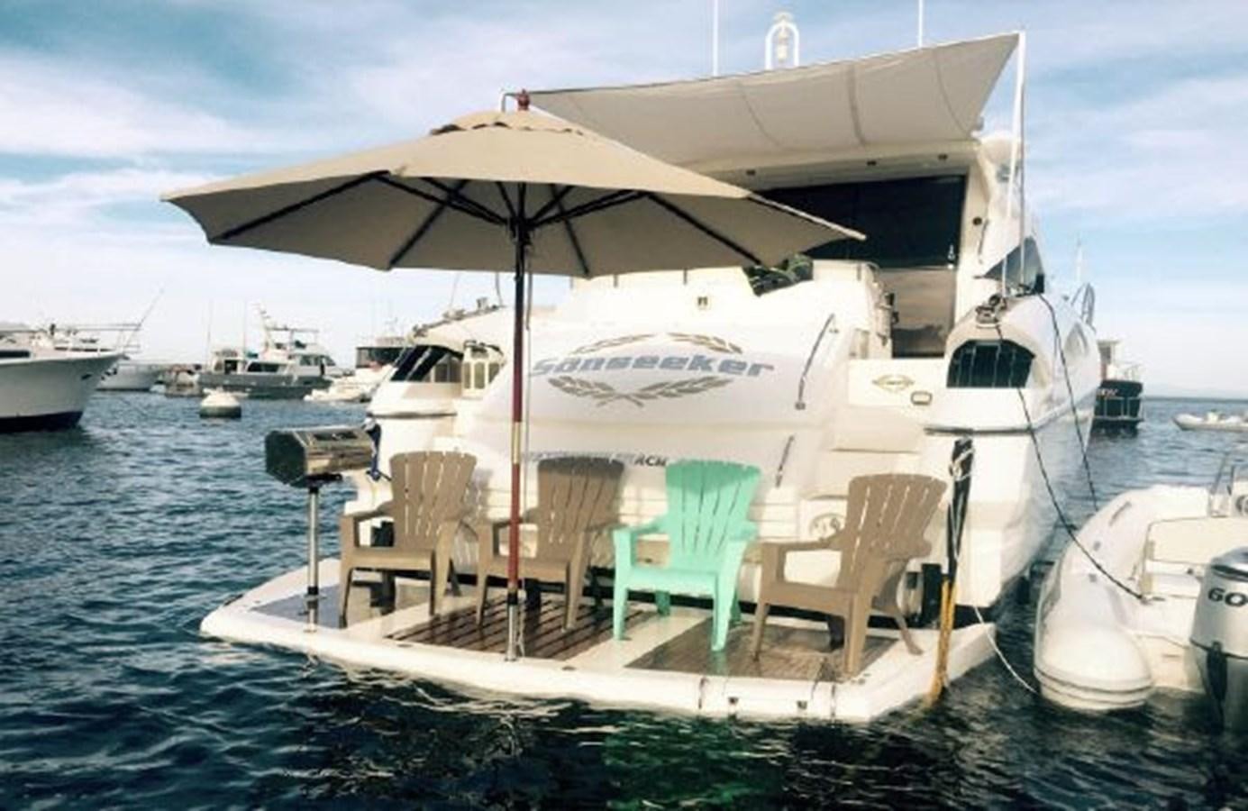 a boat with chairs and umbrellas aboard SONSEEKER Yacht for Sale