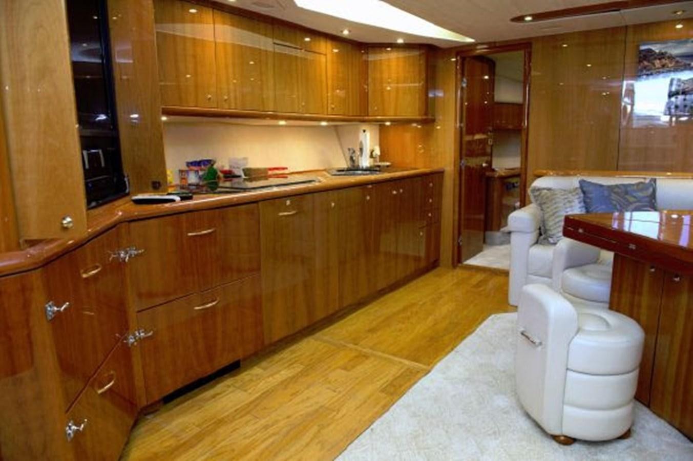 a kitchen with wooden cabinets aboard SONSEEKER Yacht for Sale