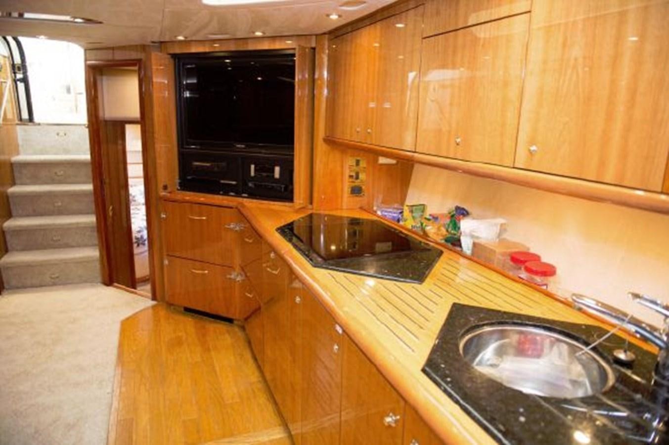 a kitchen with wooden cabinets aboard SONSEEKER Yacht for Sale