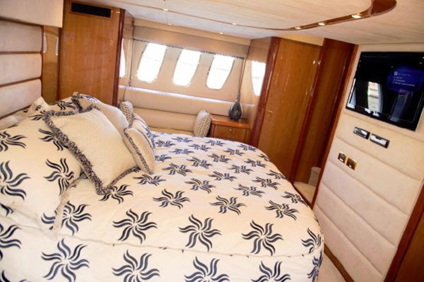 a bed with a floral comforter aboard SONSEEKER Yacht for Sale