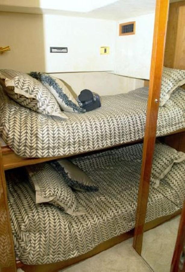 a bed with a blue hat on it aboard SONSEEKER Yacht for Sale