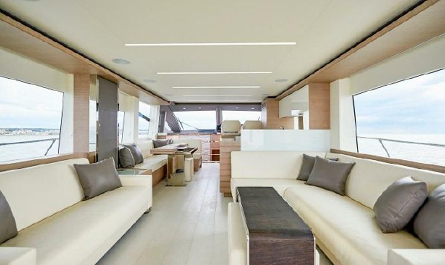 a living room with a couch and a large window aboard 2021 ASTONDOA 66 FLYBRIDGE Yacht for Sale