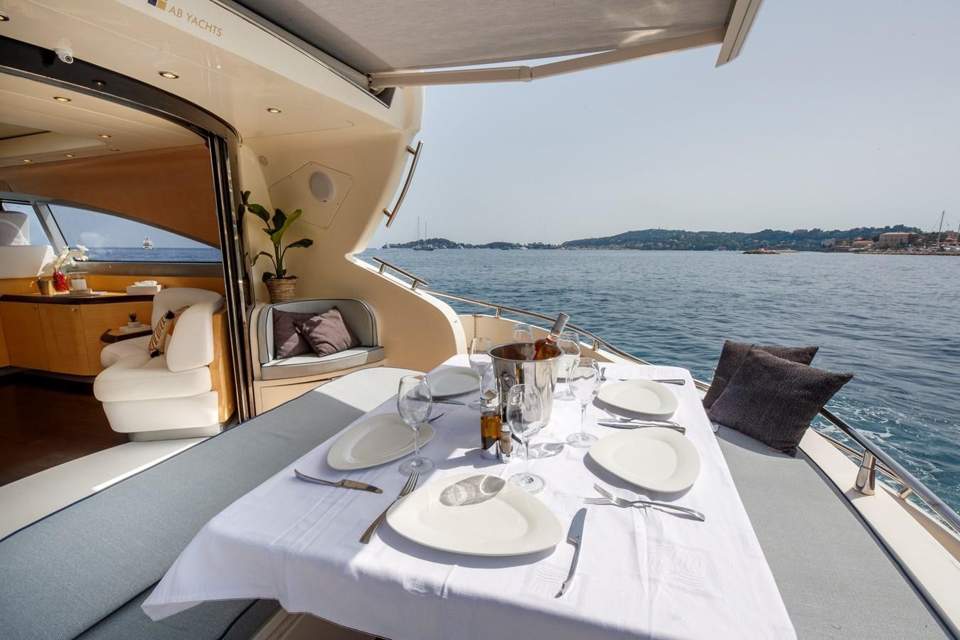 a table with plates and glasses on it aboard KOKAB Yacht for Charter