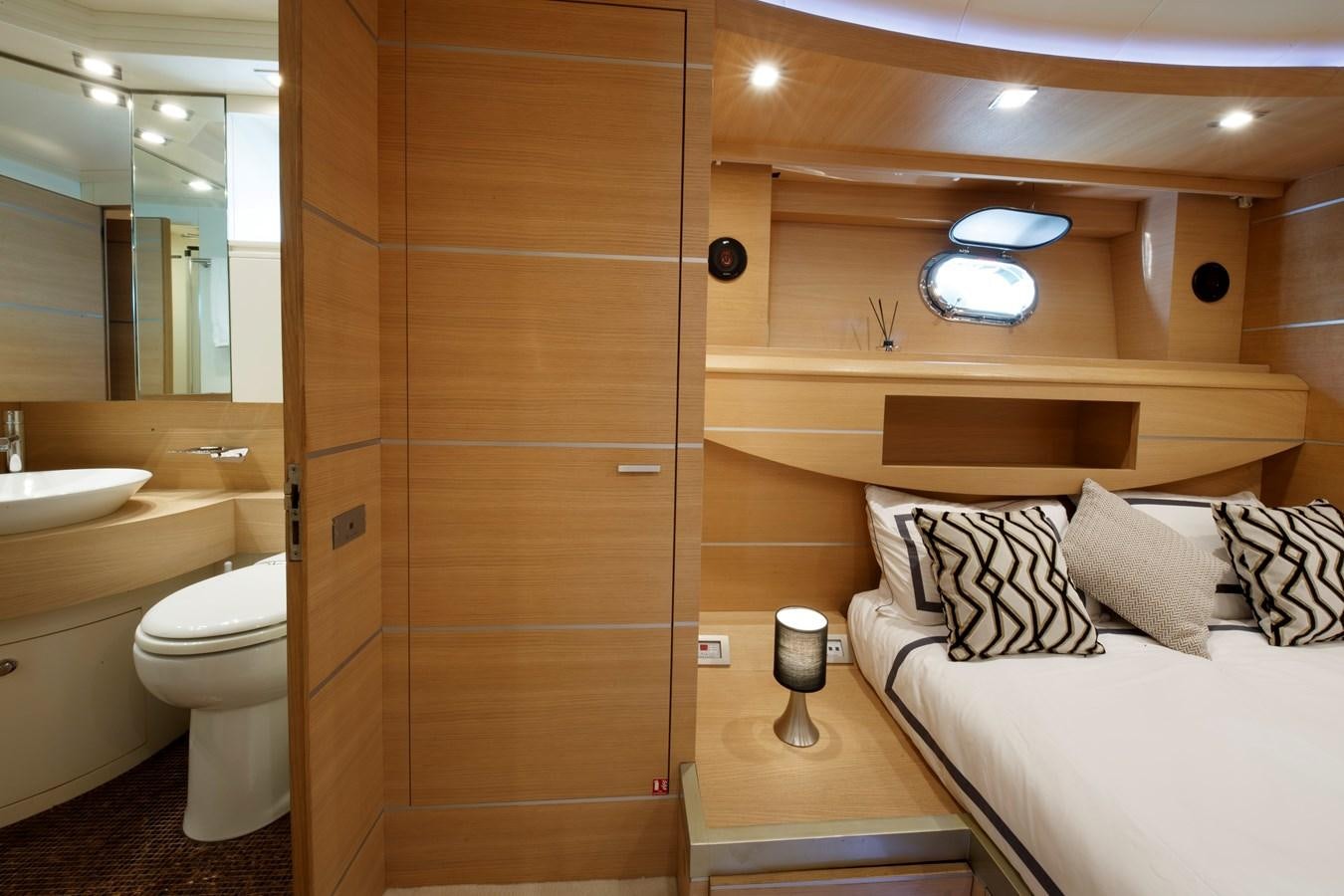 a bathroom with a bed and a shower aboard KOKAB Yacht for Charter