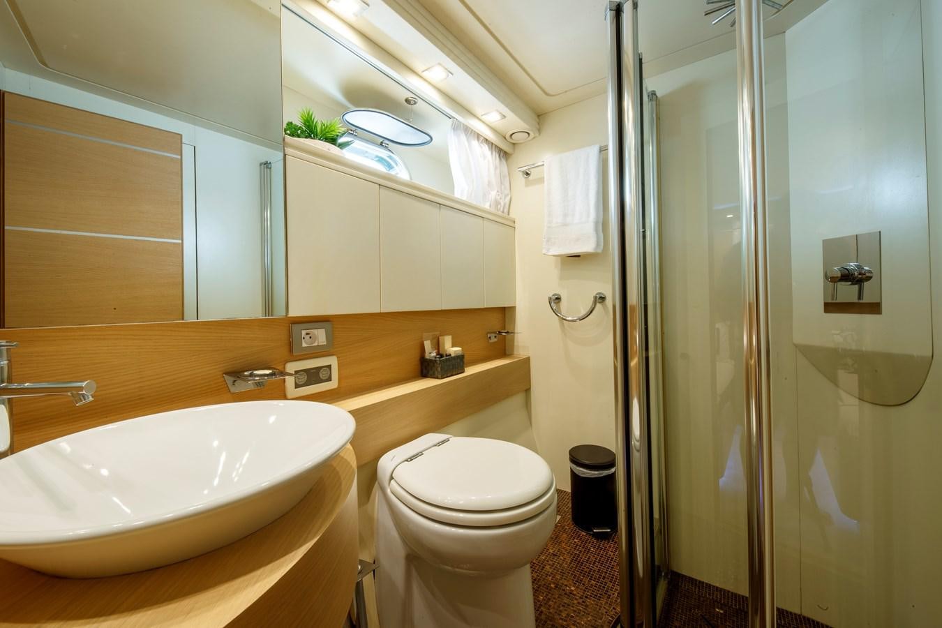 a bathroom with a sink toilet and shower aboard KOKAB Yacht for Charter