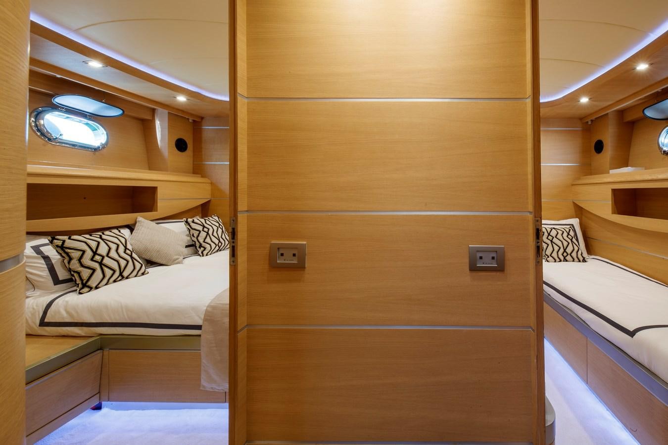 a room with a bed and a wood cabinet aboard KOKAB Yacht for Charter