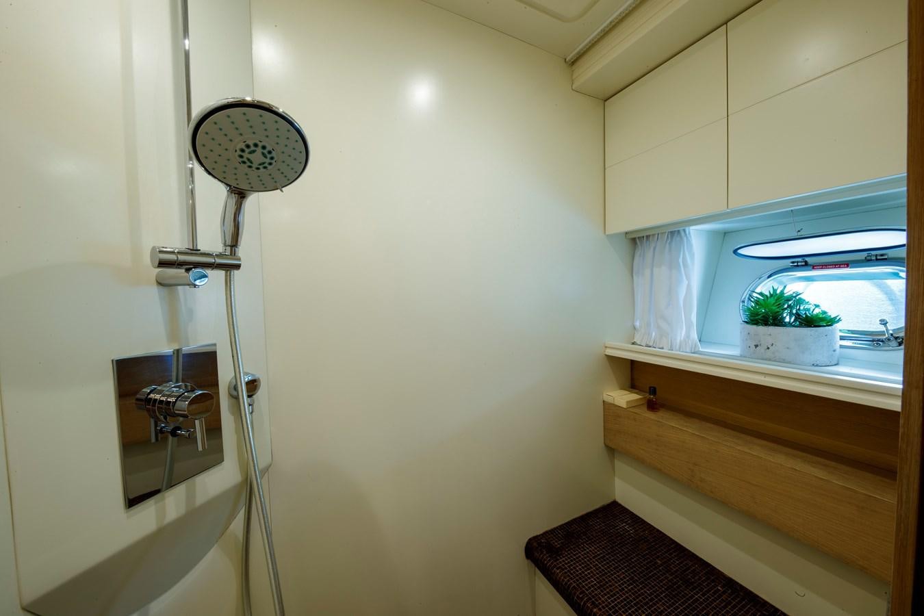 a white wall with a plant on it aboard KOKAB Yacht for Charter