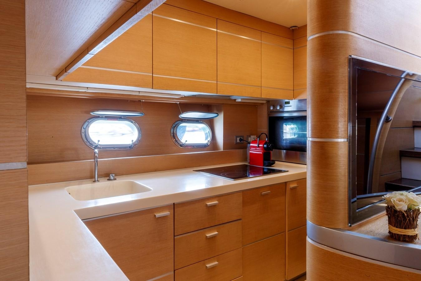 a kitchen with a sink and a microwave aboard KOKAB Yacht for Charter