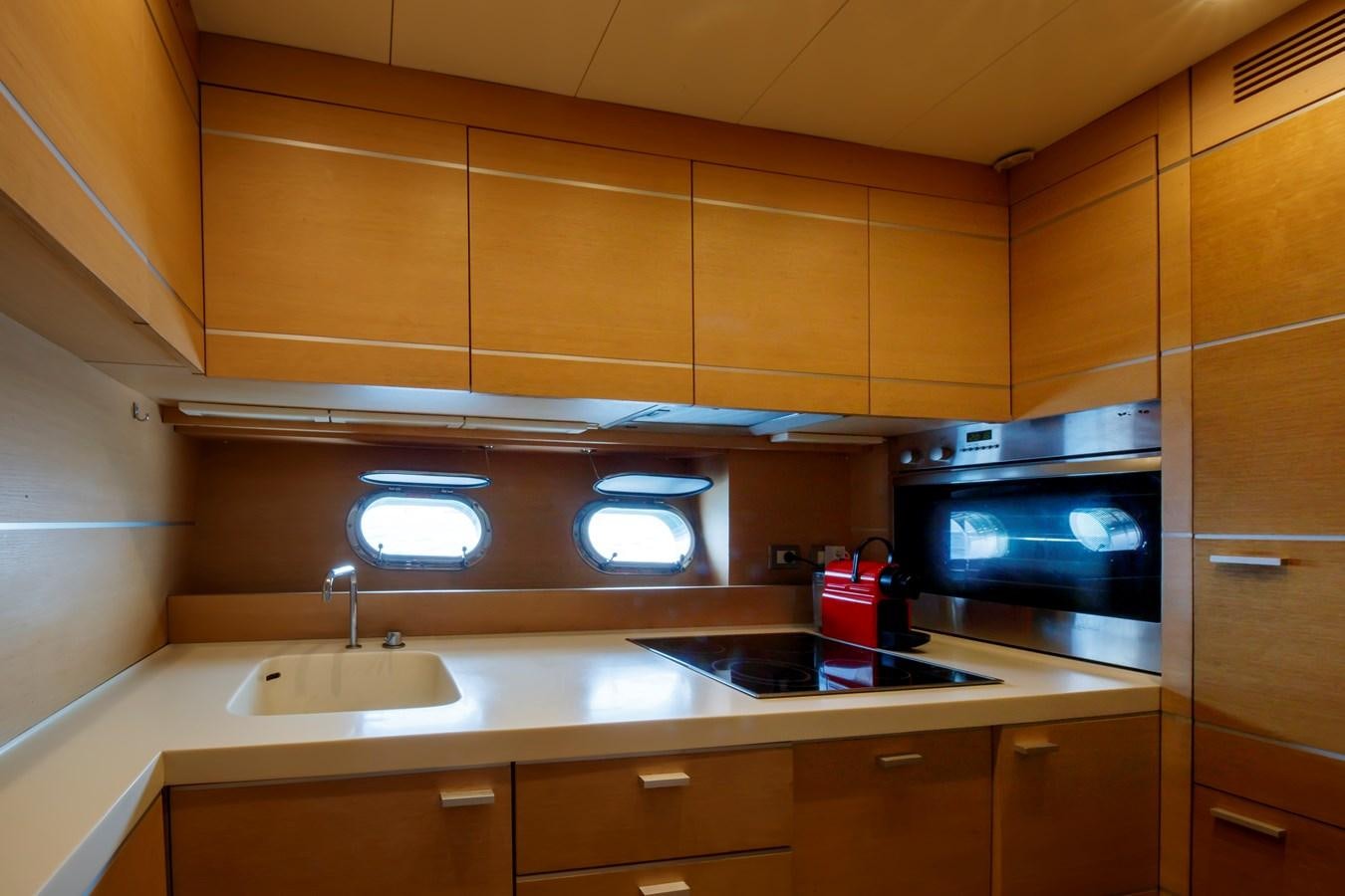 a kitchen with a microwave oven and a sink aboard KOKAB Yacht for Charter