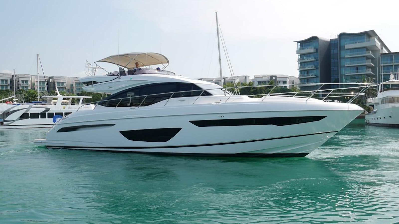 a white yacht in a harbor aboard KATI Yacht for Sale