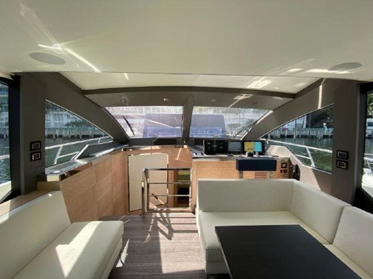 a room with couches and a table aboard THE ONLY BLUE 66 FLY Yacht for Sale