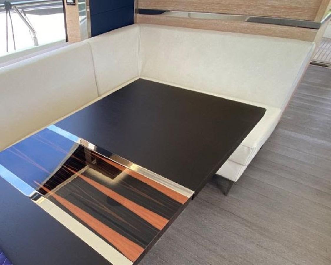 a large black rectangular object on a wooden surface aboard THE ONLY BLUE 66 FLY Yacht for Sale