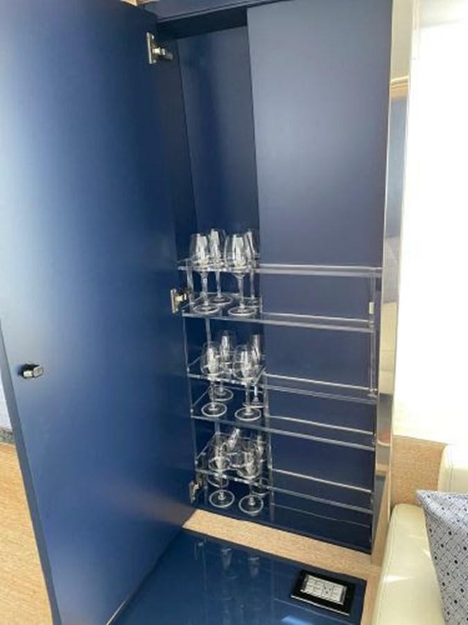 a glass cabinet with a clear door aboard THE ONLY BLUE 66 FLY Yacht for Sale