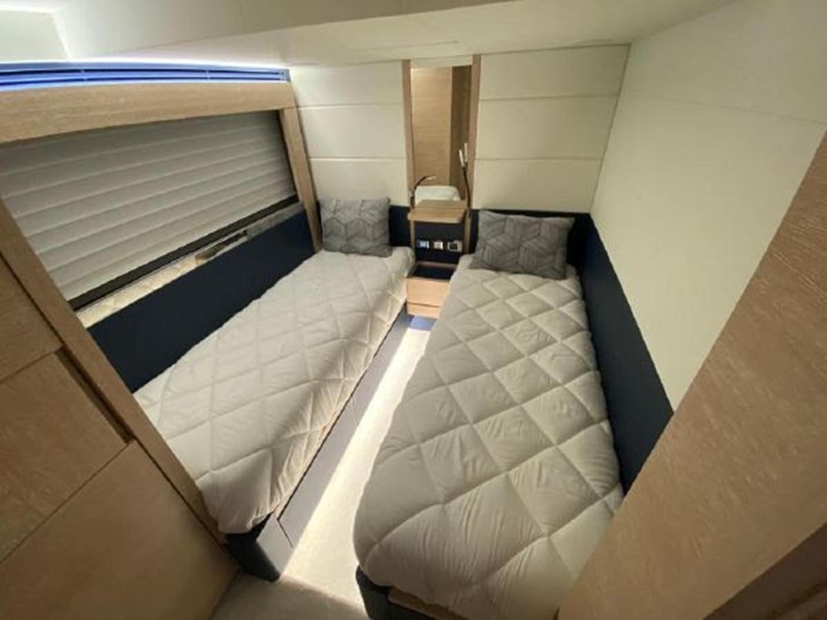 a bed with a white comforter aboard THE ONLY BLUE 66 FLY Yacht for Sale