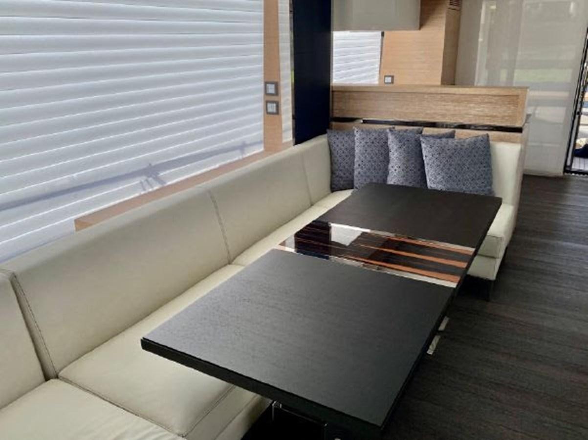a couch and coffee table aboard THE ONLY BLUE 66 FLY Yacht for Sale