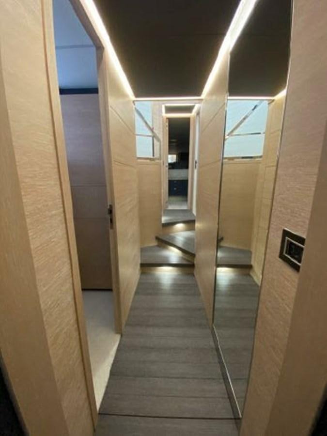 a long hallway with glass doors aboard THE ONLY BLUE 66 FLY Yacht for Sale
