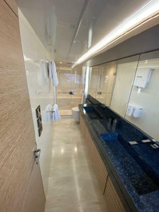 a bathroom with a large mirror aboard THE ONLY BLUE 66 FLY Yacht for Sale