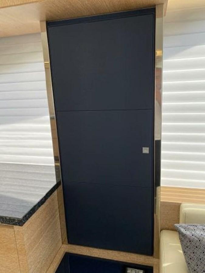 a black cabinet with a white door aboard THE ONLY BLUE 66 FLY Yacht for Sale