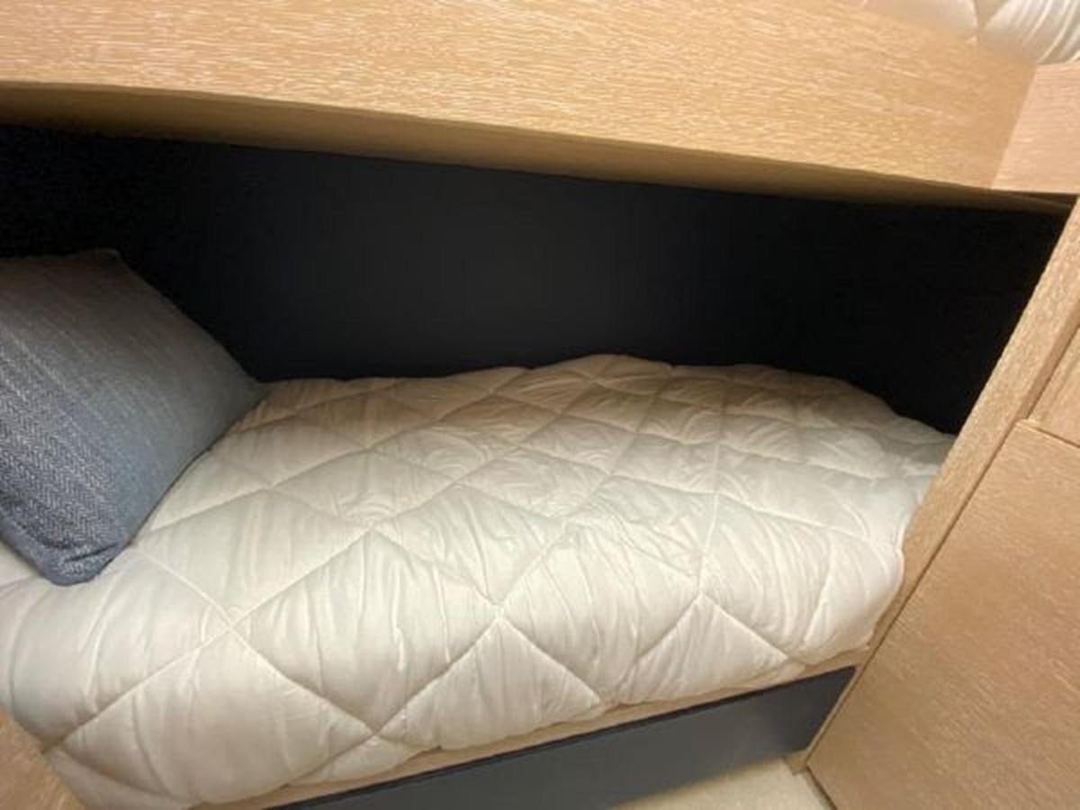 a bed with a white sheet aboard THE ONLY BLUE 66 FLY Yacht for Sale