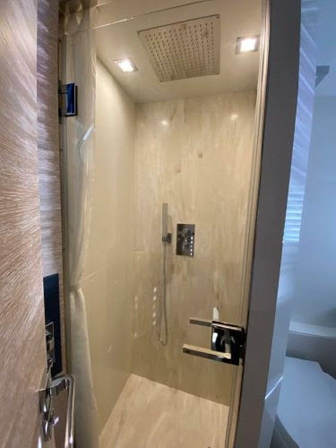 a door with a light on the wall aboard THE ONLY BLUE 66 FLY Yacht for Sale