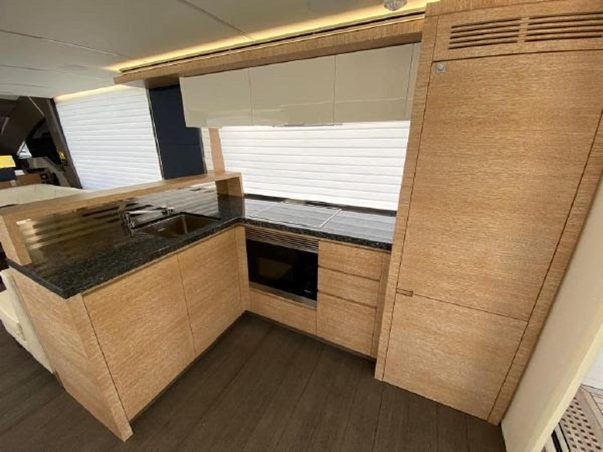 a kitchen with a wooden floor aboard THE ONLY BLUE 66 FLY Yacht for Sale