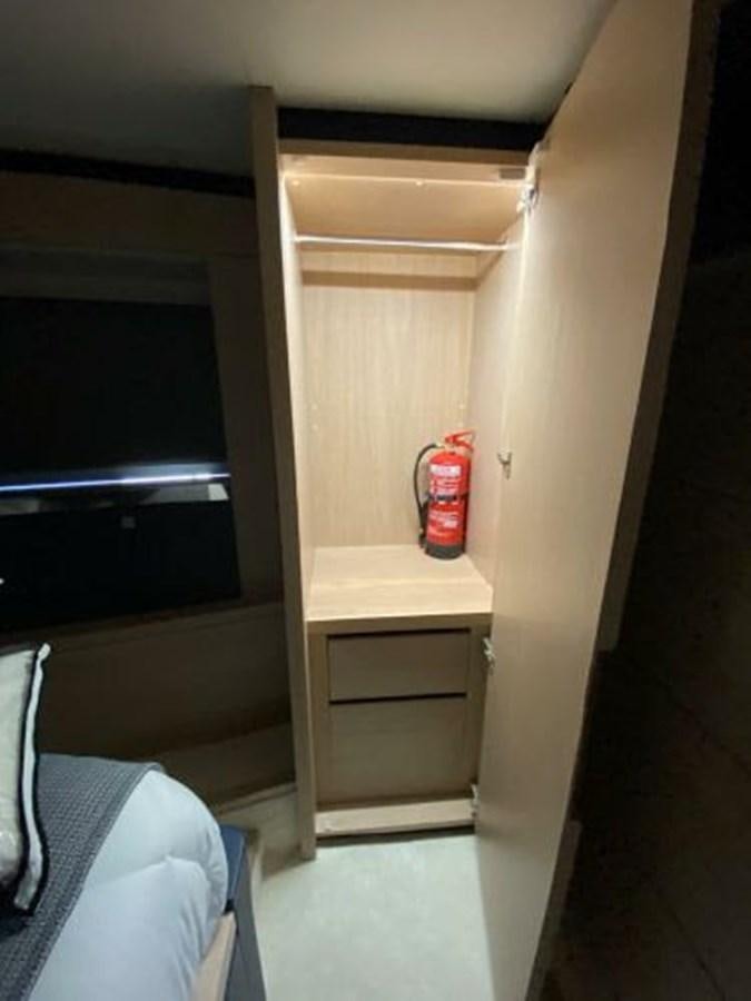 a room with a bed and a desk aboard THE ONLY BLUE 66 FLY Yacht for Sale