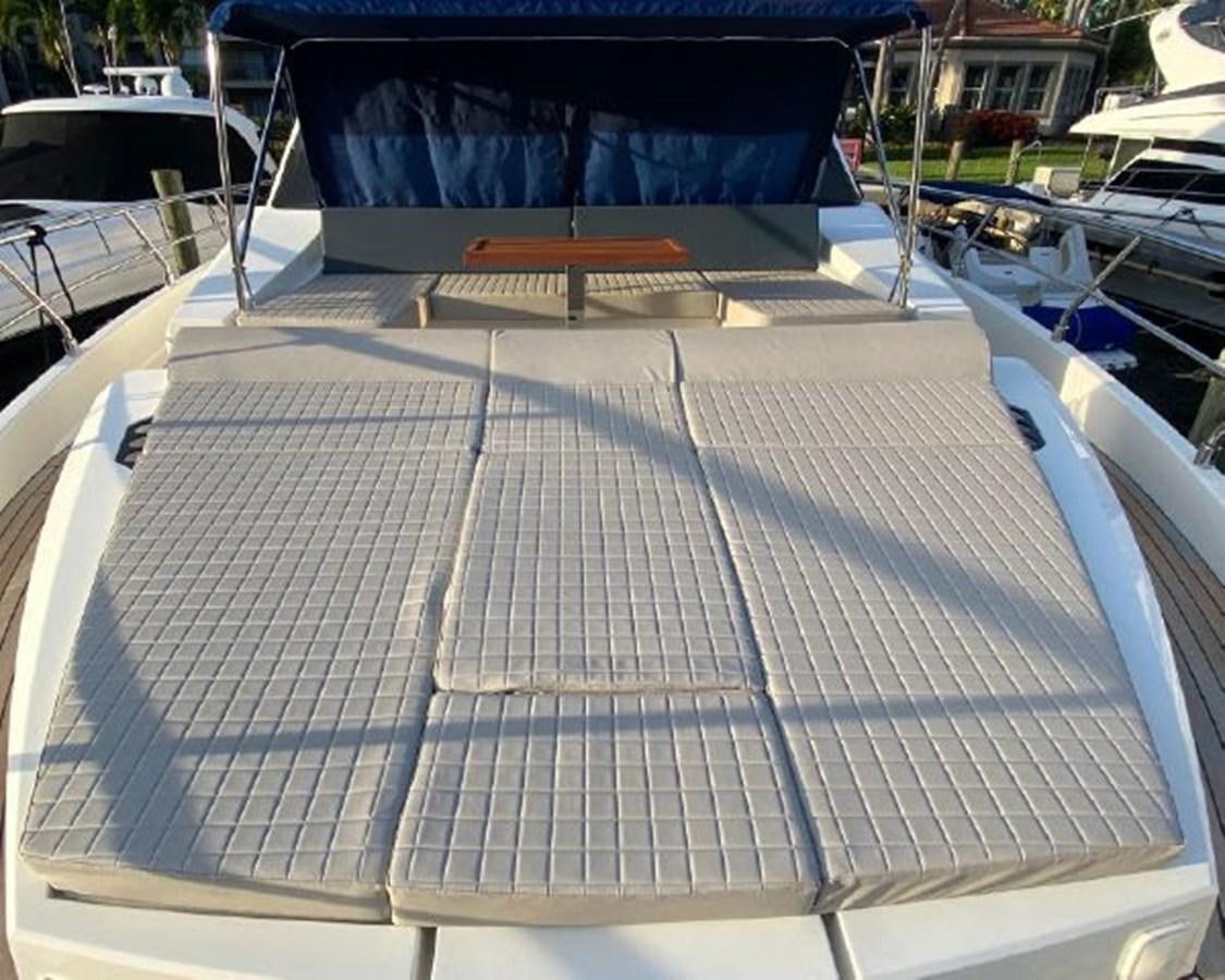 a deck with a table and chairs aboard THE ONLY BLUE 66 FLY Yacht for Sale