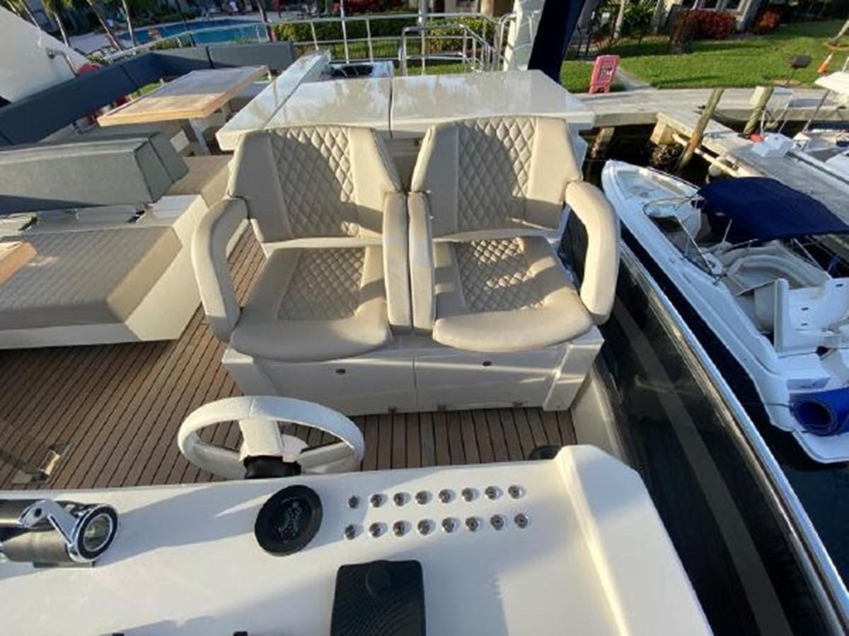 a boat with a seat aboard THE ONLY BLUE 66 FLY Yacht for Sale