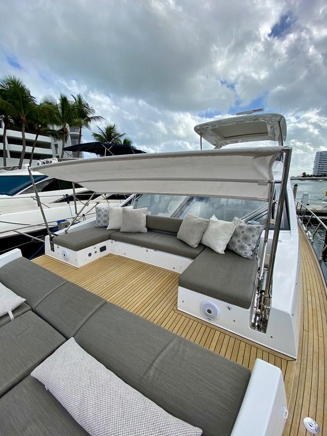 a deck with a couch and a pool aboard SEARENITY II Yacht for Sale