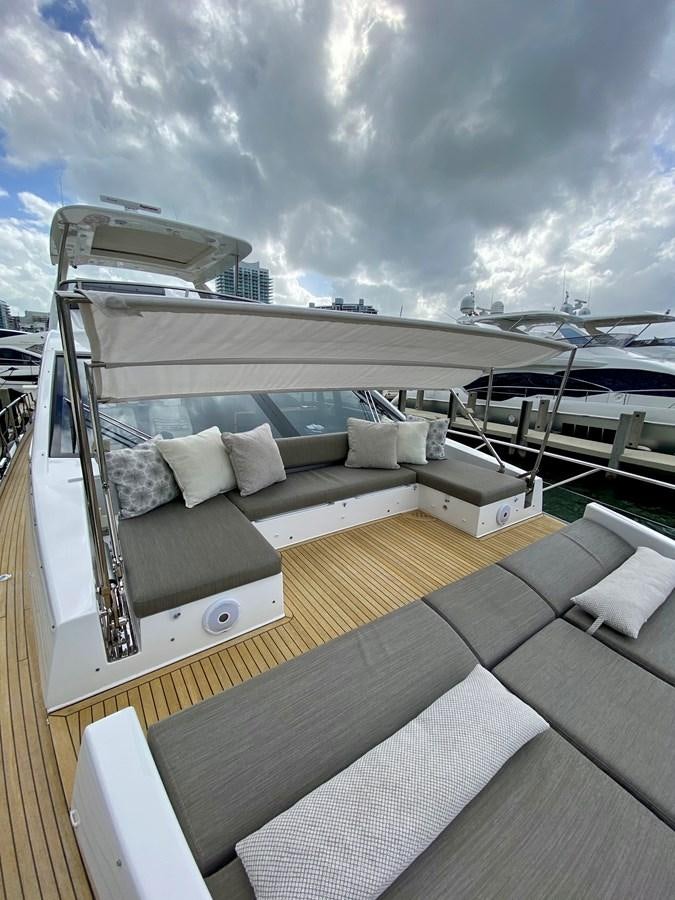 a deck with a view of a city and the ocean aboard SEARENITY II Yacht for Sale