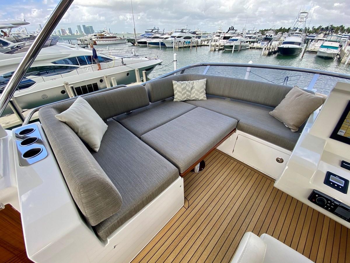 a room with a couch and a table with chairs on it aboard SEARENITY II Yacht for Sale