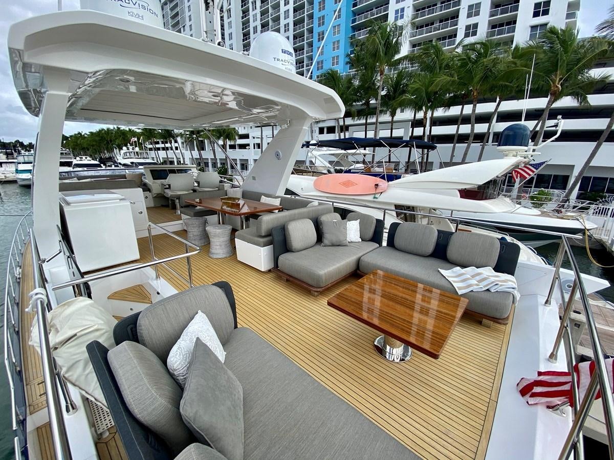 a room with a couch and chairs aboard SEARENITY II Yacht for Sale