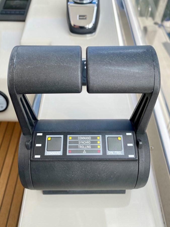 a black rectangular object with a silver screen and buttons aboard SEARENITY II Yacht for Sale