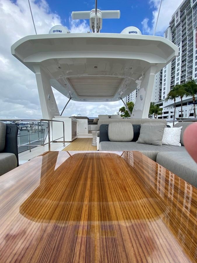 a deck with a couch and a pool aboard SEARENITY II Yacht for Sale