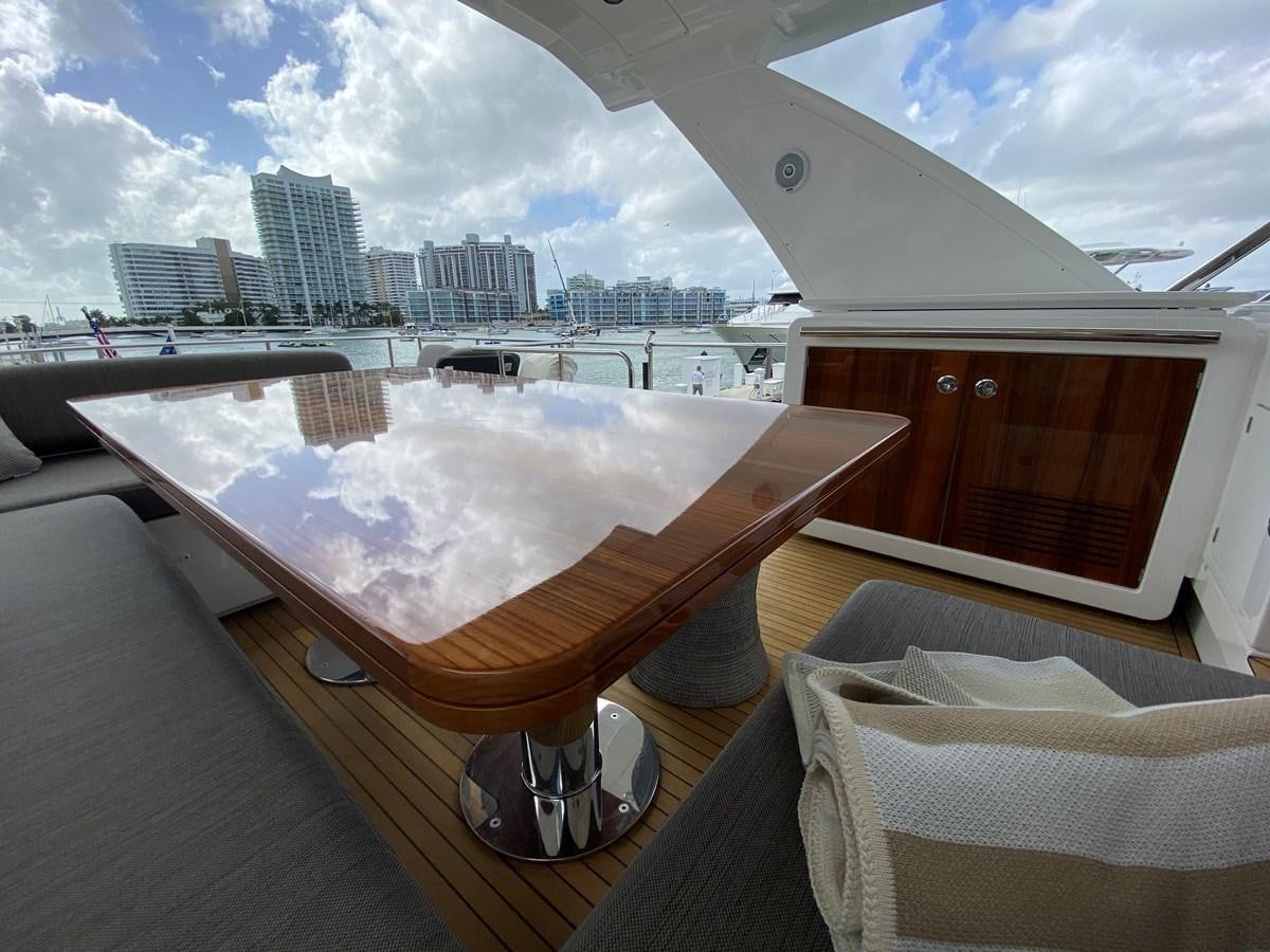 a deck with a large body of water and a city in the background aboard SEARENITY II Yacht for Sale