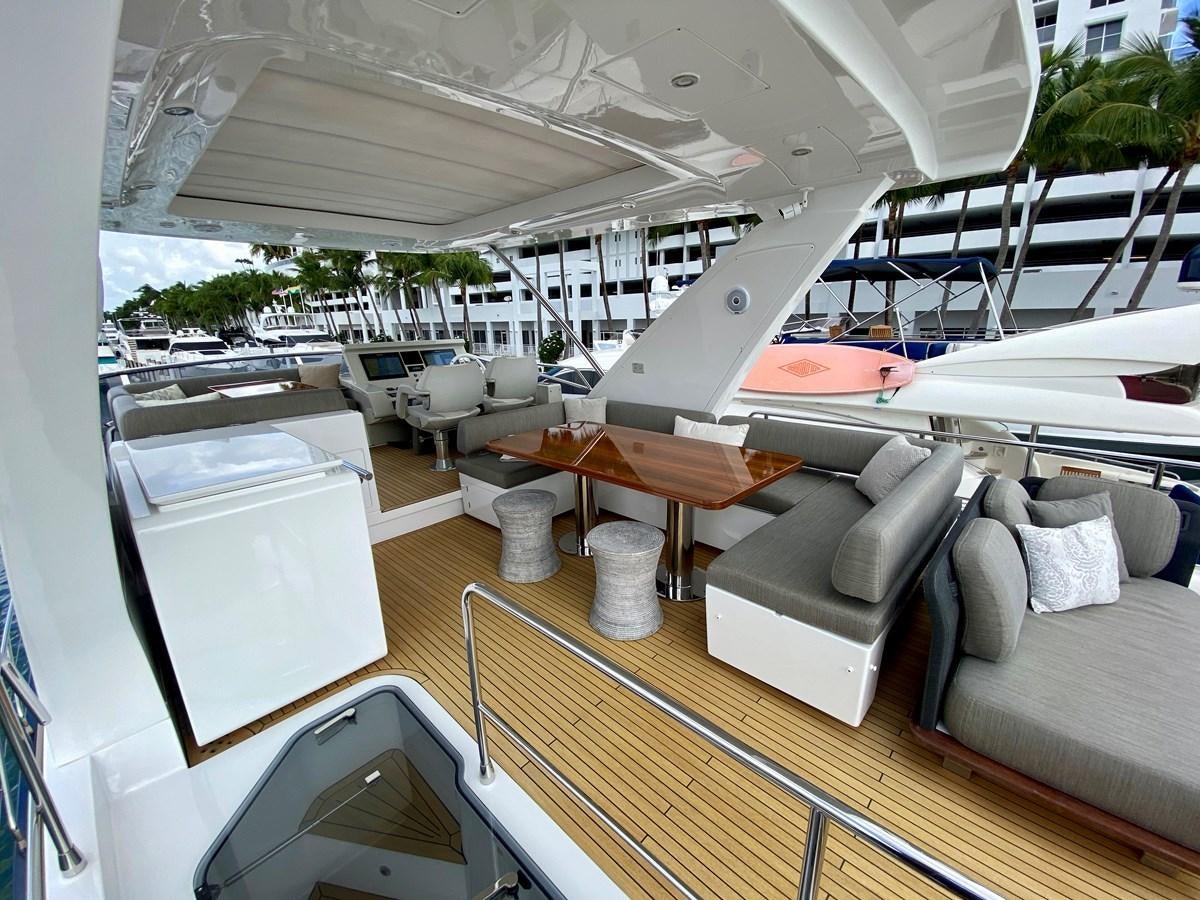 a room with a couch and a table and chairs aboard SEARENITY II Yacht for Sale