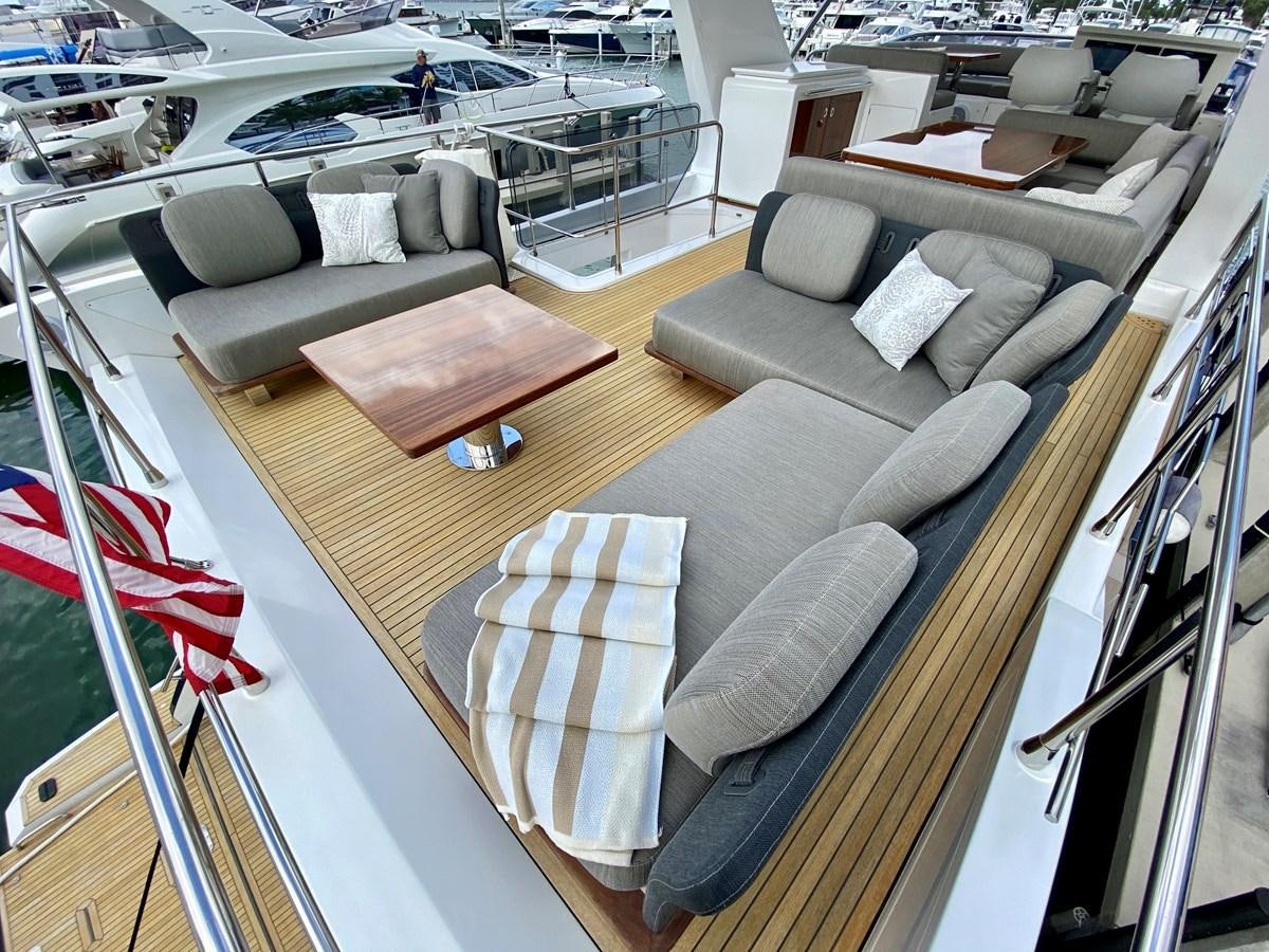 a boat with a couch and chairs aboard SEARENITY II Yacht for Sale