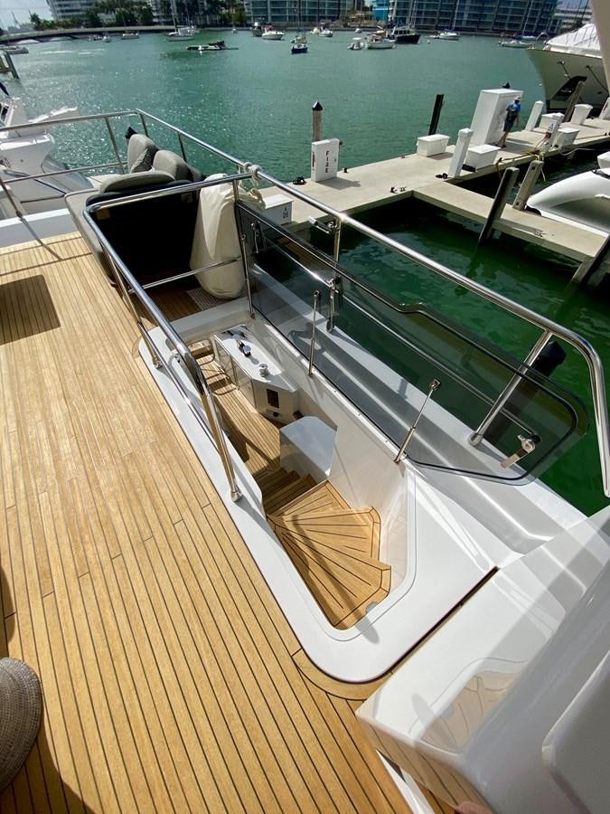 a deck with a deck and chairs on it aboard SEARENITY II Yacht for Sale