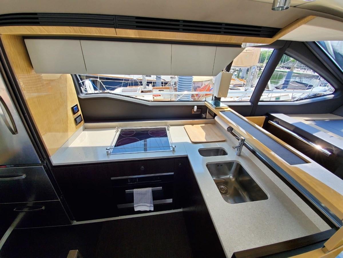 a kitchen with a sink and a stove aboard SEARENITY II Yacht for Sale