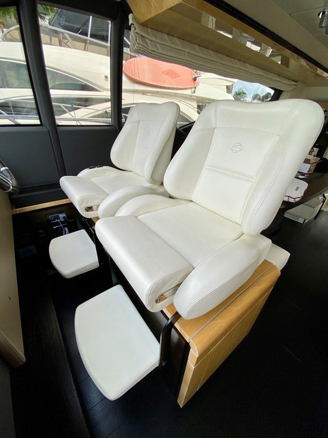 a white chair with a seat aboard SEARENITY II Yacht for Sale