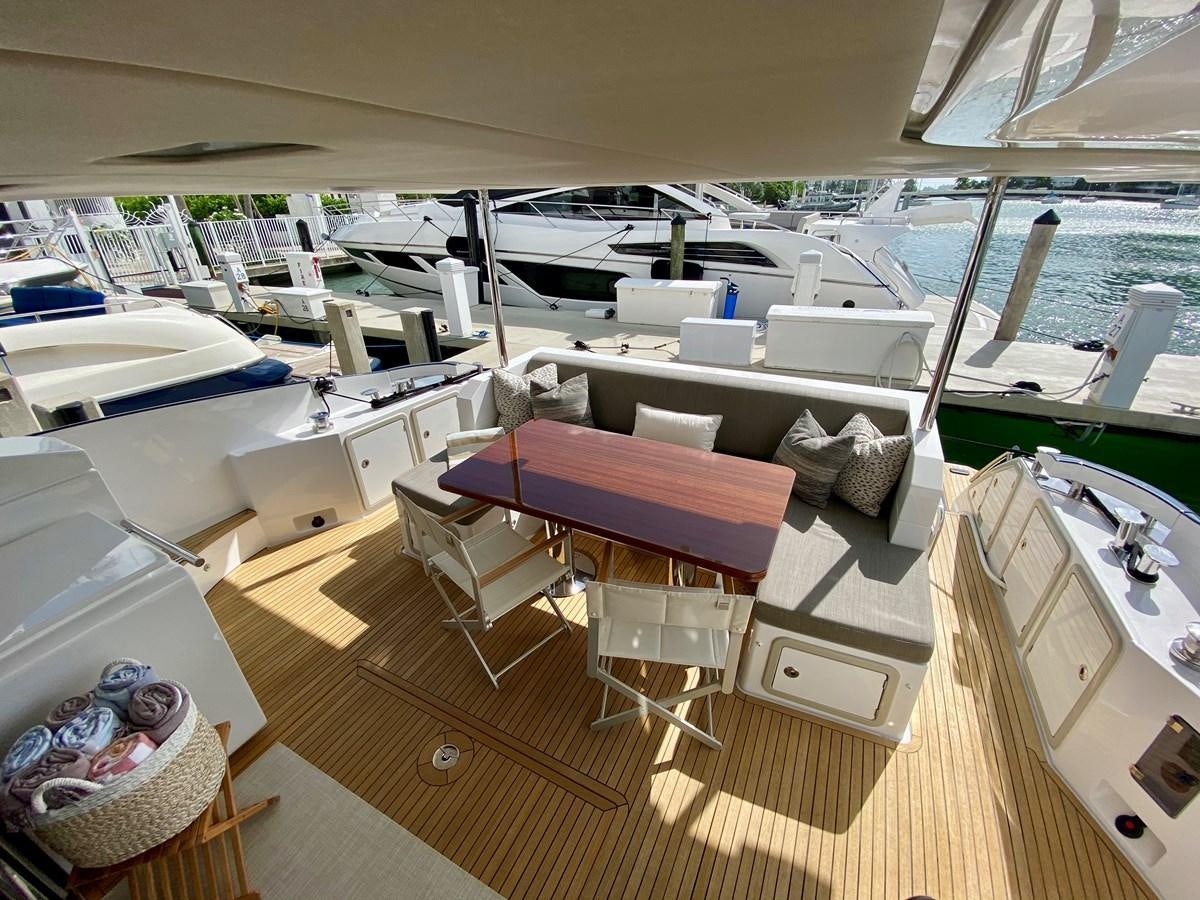a boat with a table and chairs aboard SEARENITY II Yacht for Sale