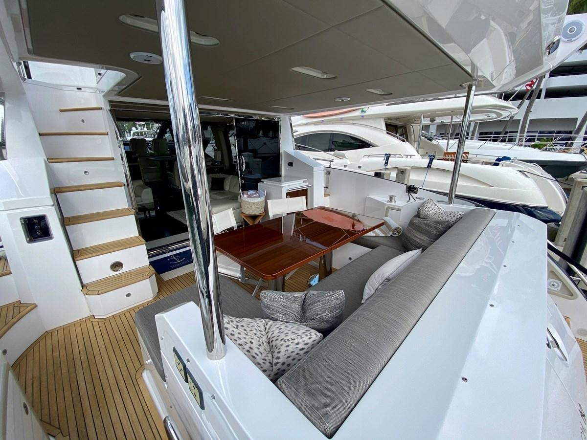 a room with a bed and a couch aboard SEARENITY II Yacht for Sale