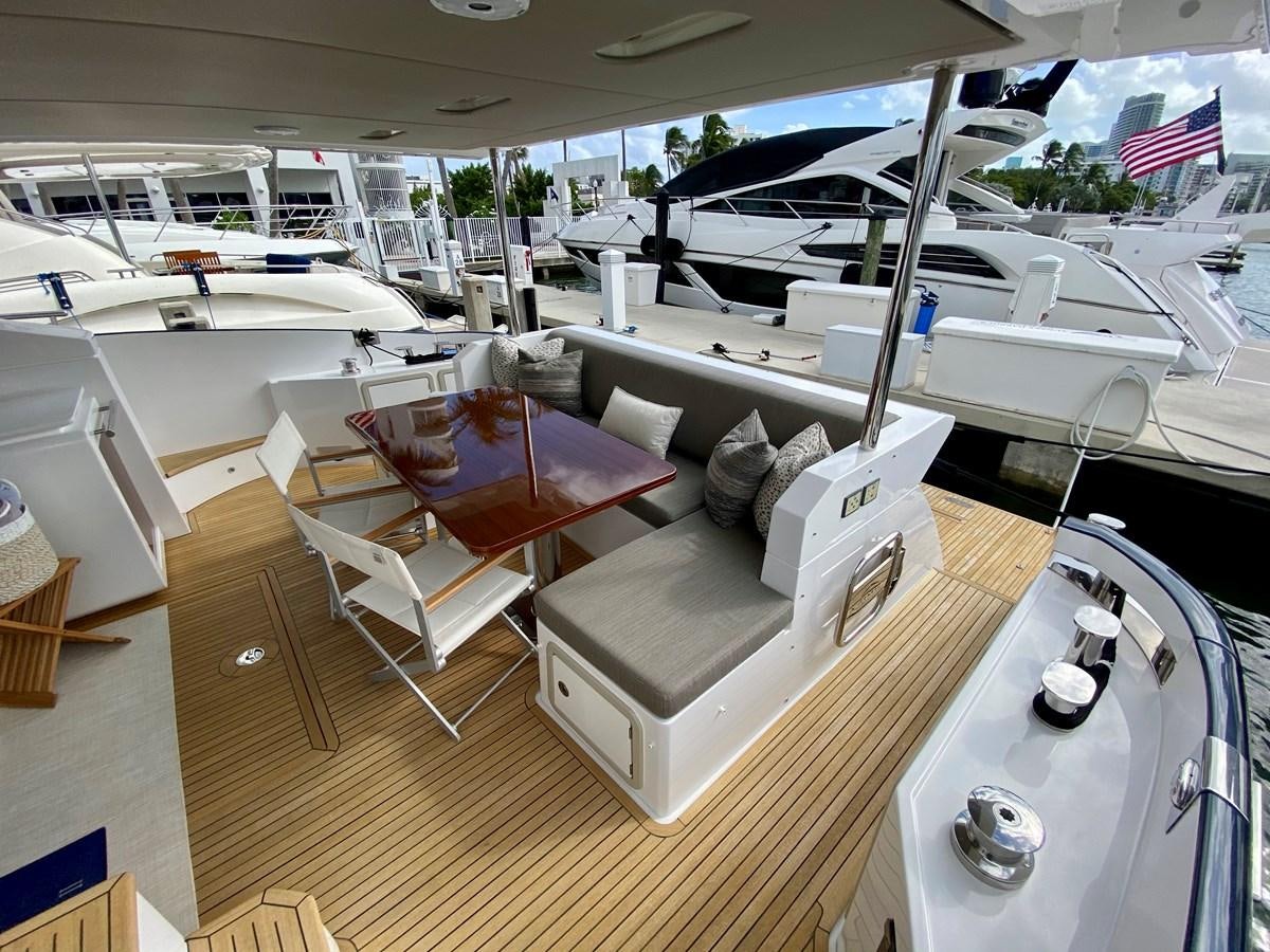 a room with a couch and chairs aboard SEARENITY II Yacht for Sale