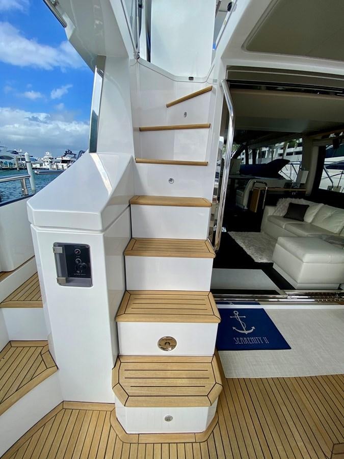 a wood staircase in a room aboard SEARENITY II Yacht for Sale