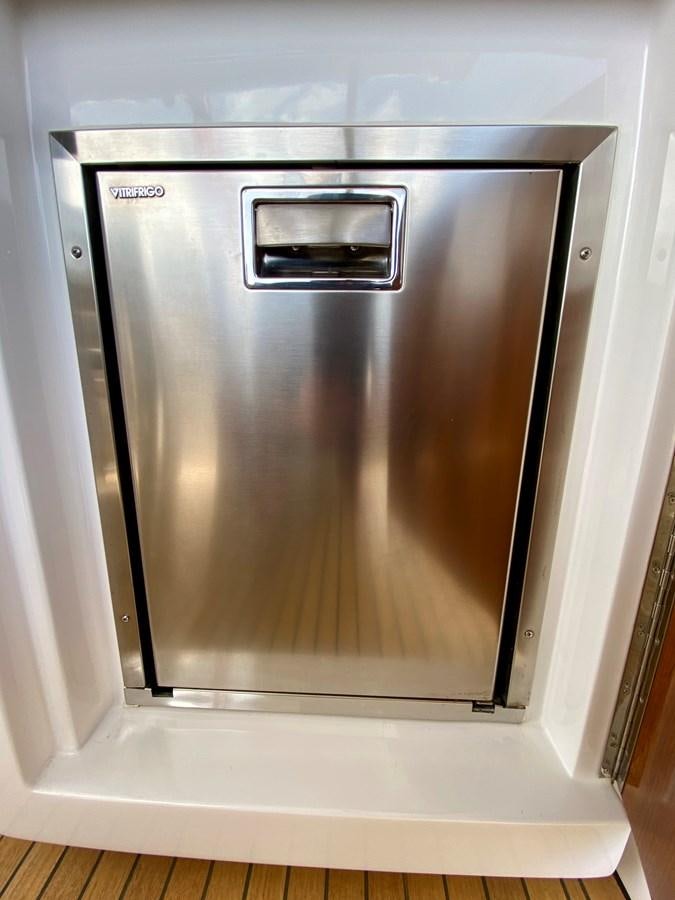 a silver refrigerator in a kitchen aboard SEARENITY II Yacht for Sale