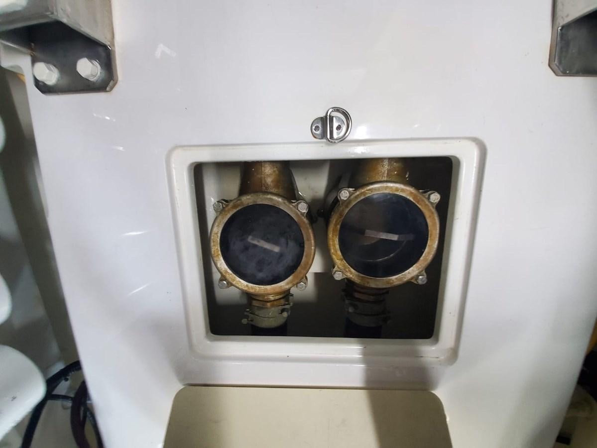 a pair of gold rings on a white surface aboard SEARENITY II Yacht for Sale